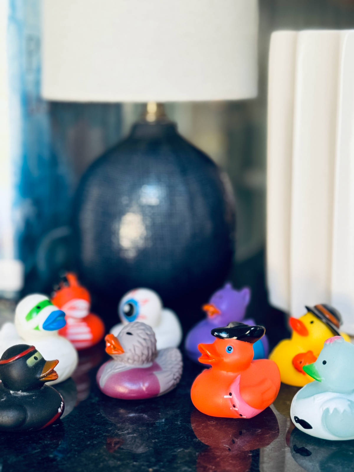 Halloween duckies on black countertop.
