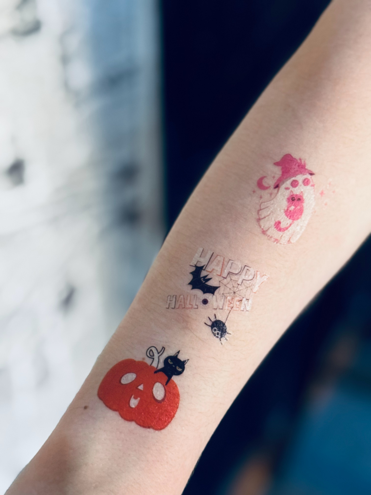 glow in the dark Halloween tattoos on arm.