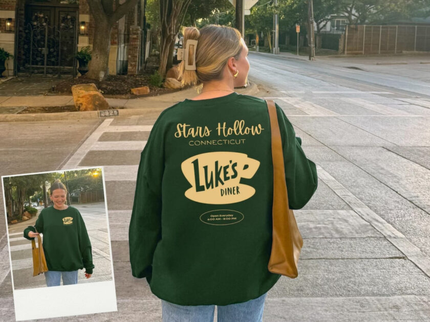 blond woman wearing dark green Stars Hollow Luke's Diner sweatshirt.