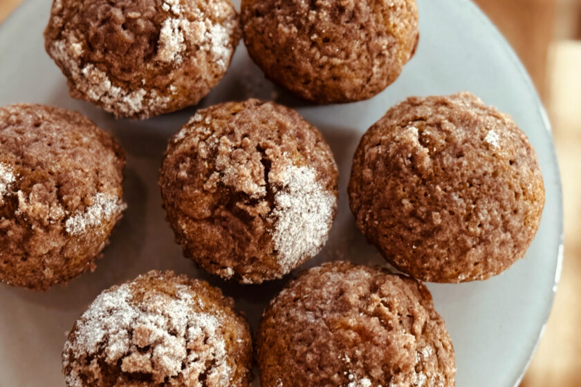 pumpkin cream cheese muffins on gray cake tray.