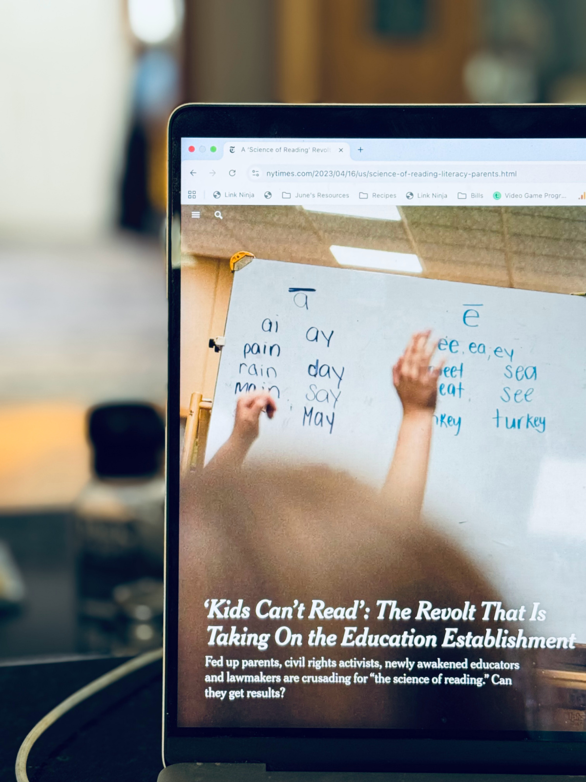 Article from the New York Times in focus on computer screen - "'Kids Can't Read' - The Revolt That Is Taking on the Education Establishment"