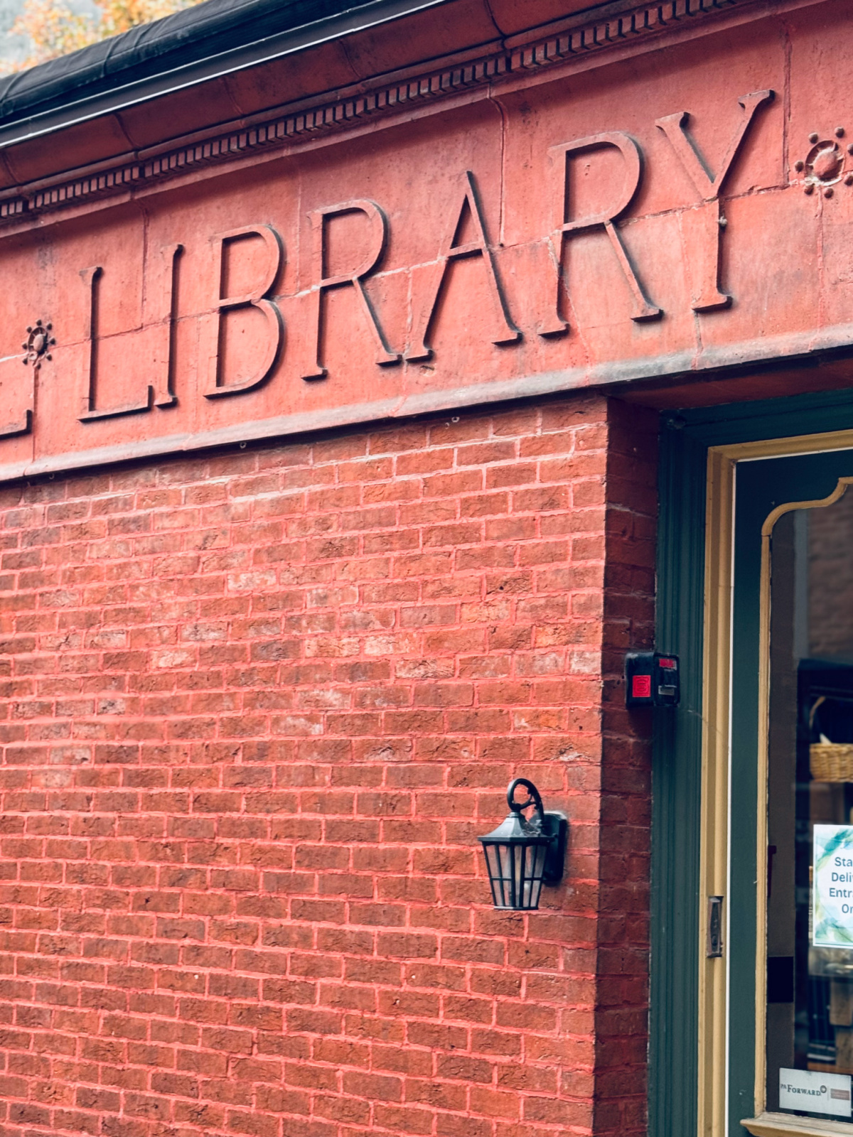 brick side of local library with the word "library" in focus.