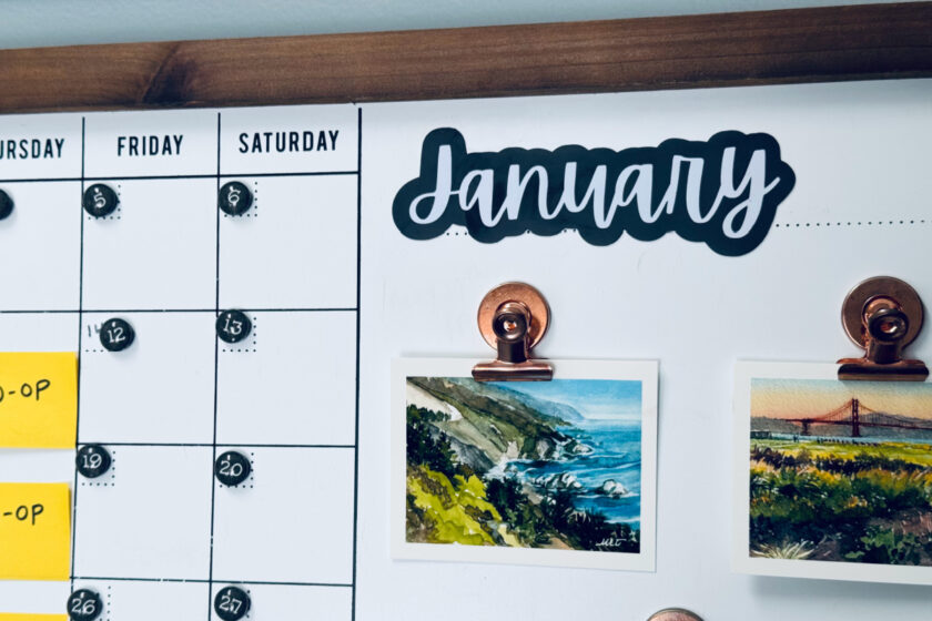 January magnet in focus on whiteboard calendar.