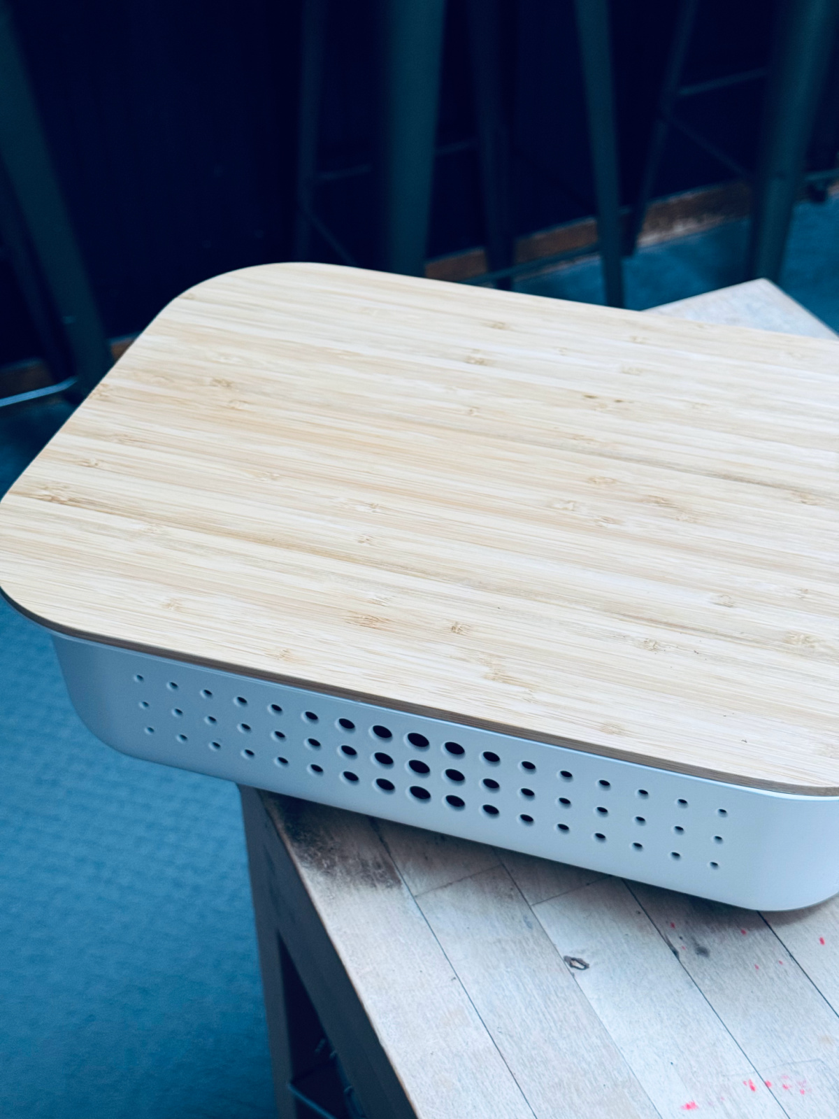 white Container Store bin with wooden lid on counter.