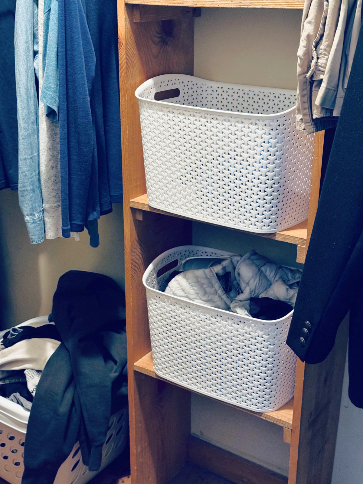 large white plastic bins in closet.
