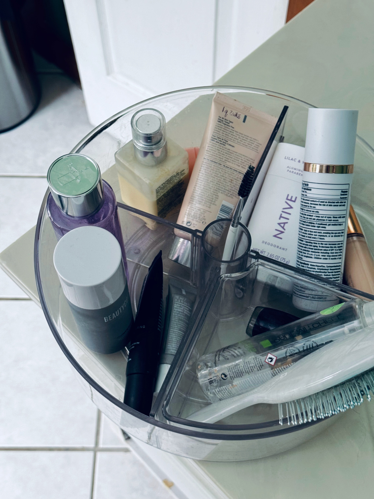 lazy susan organizer holding makeup, skincare and hair products.