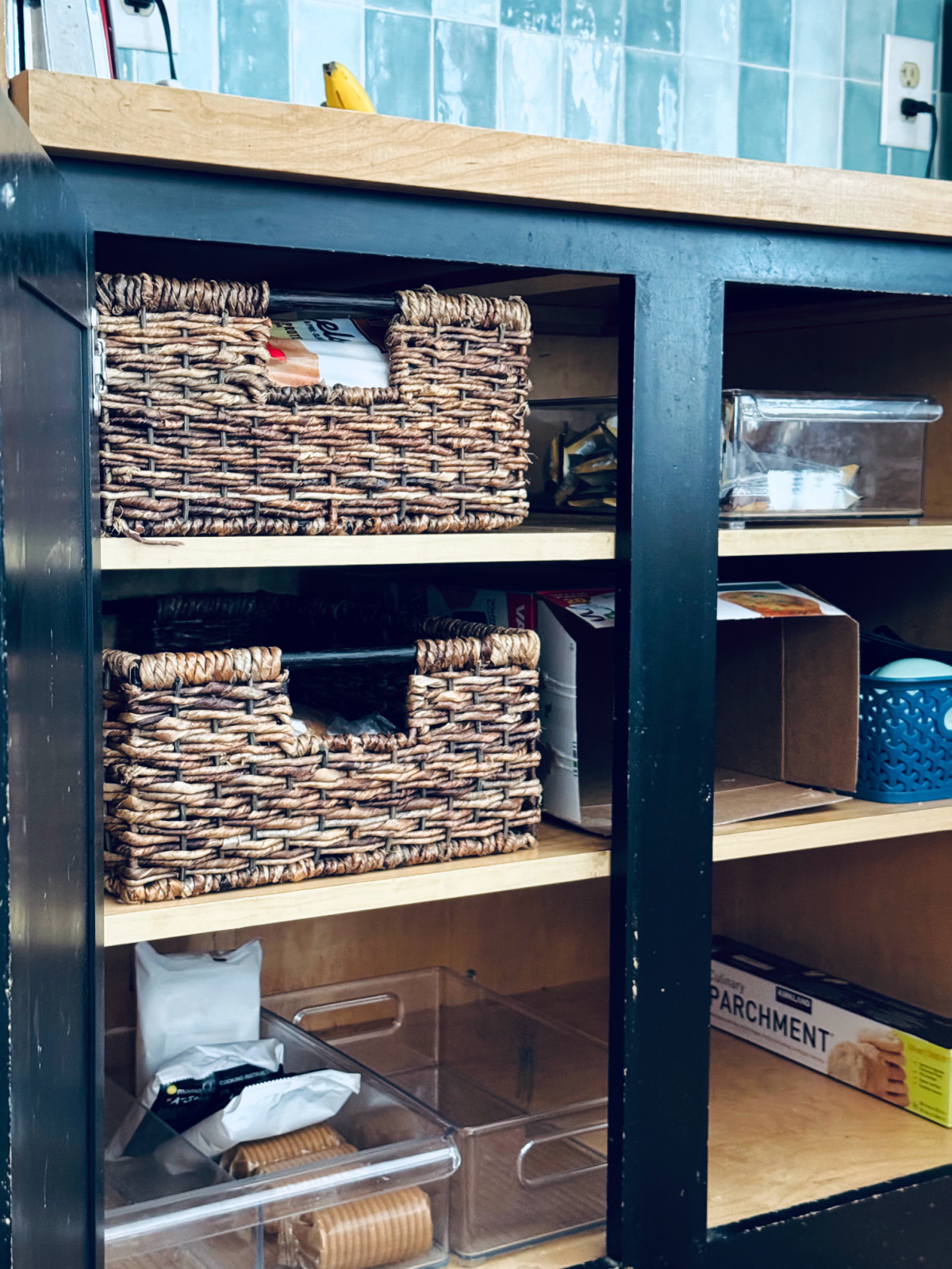 pantry cabinets with plastic fridge bins and long baskets.