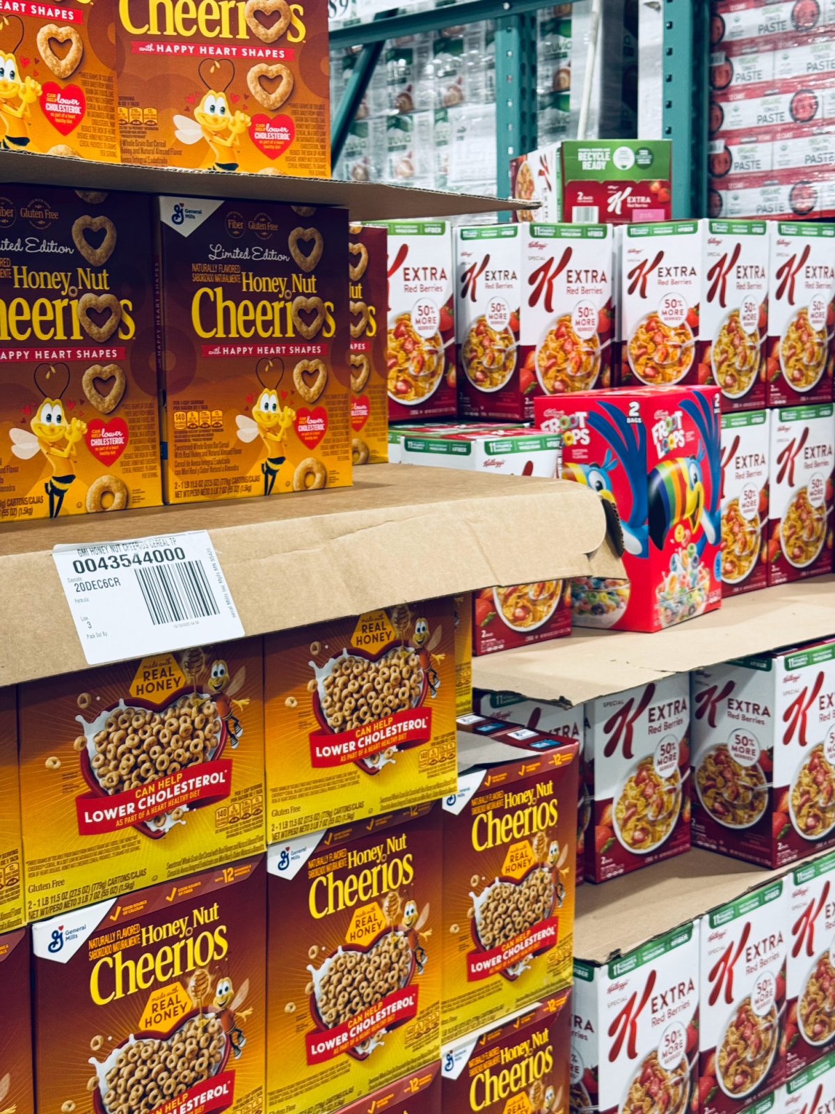 grocery section at Costco with Honey Nut Cheerios and Extra Red Berries Special K in focus.
