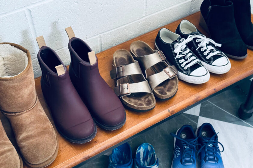 minimalist women's shoe collection lined up on bench.