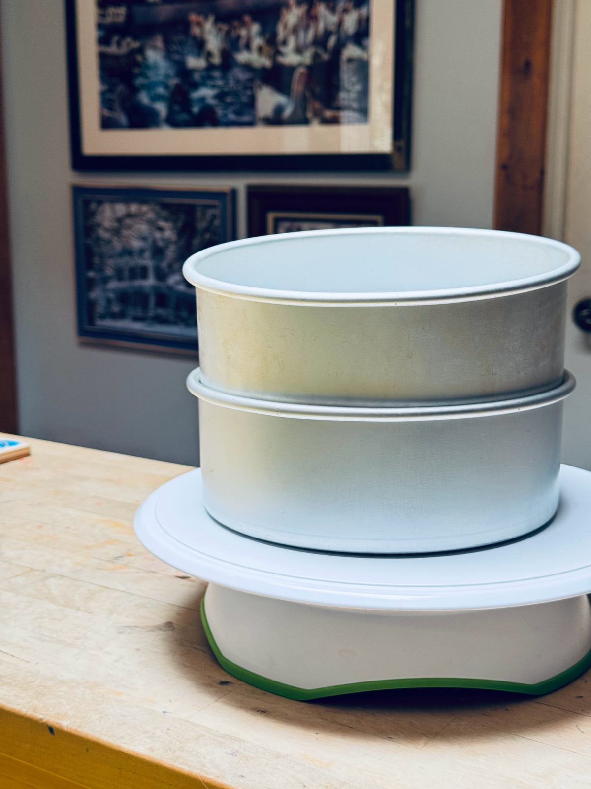 round cake pans on rotating cake stand to be decluttered.