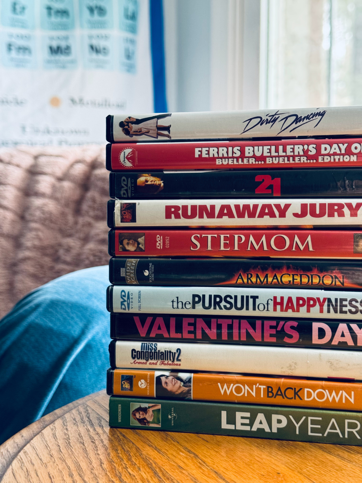 stack of dvds on side table, to be decluttered.