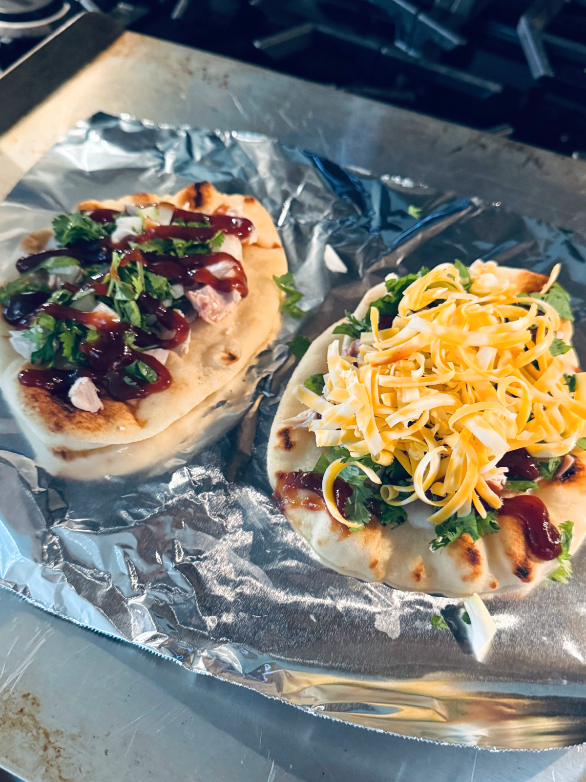 mini bbq chicken naan pizzas in process.