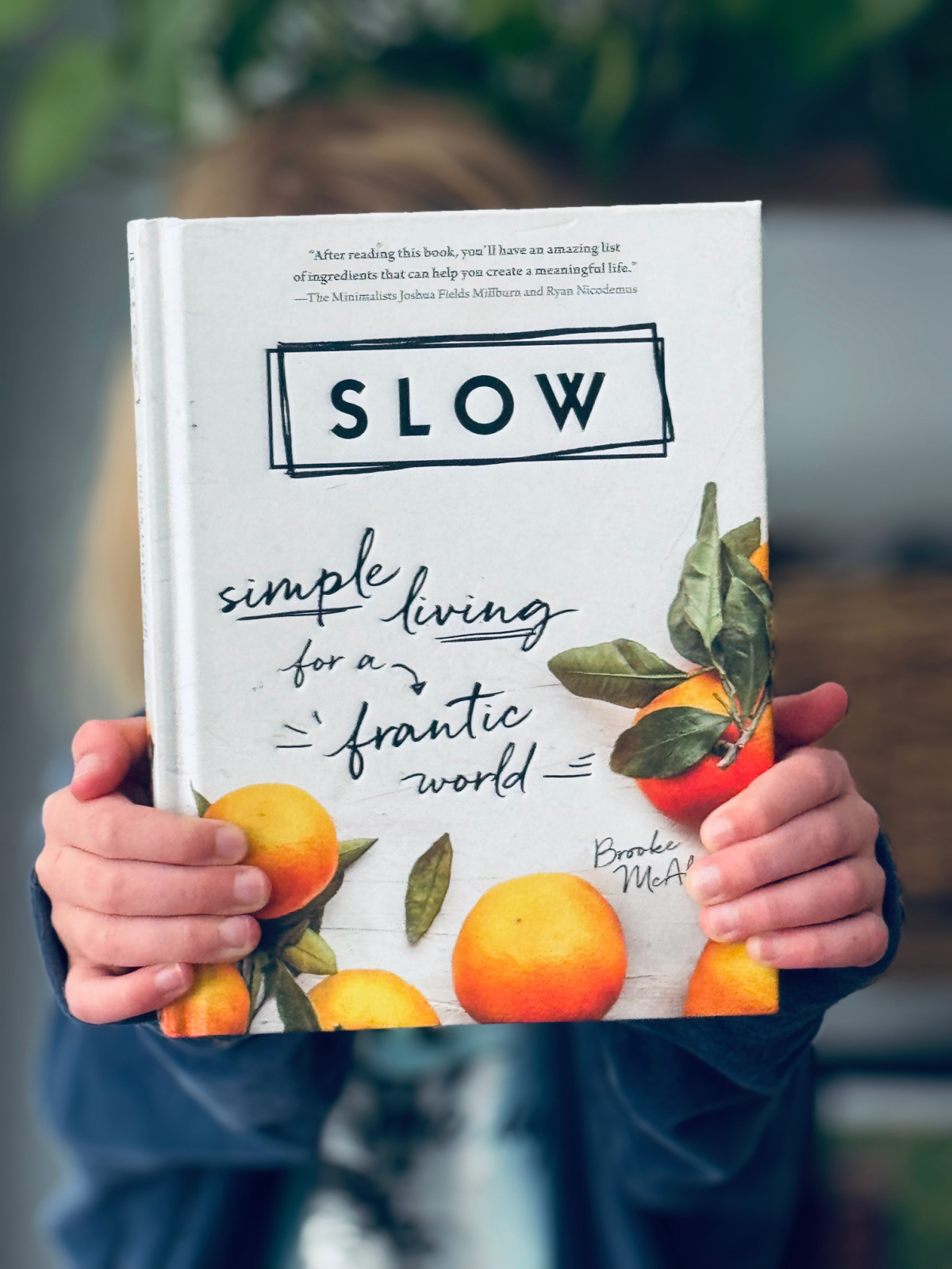 the book Slow by Brooke McAlary in focus.