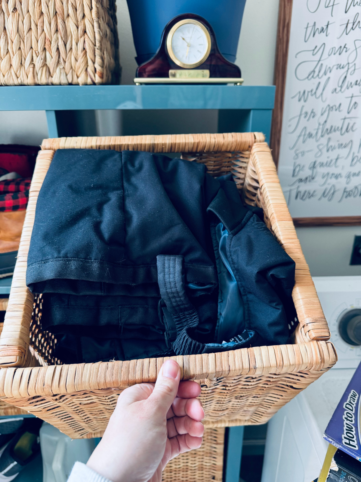 bin full of winterwear, such as snow suits, hats and gloves.