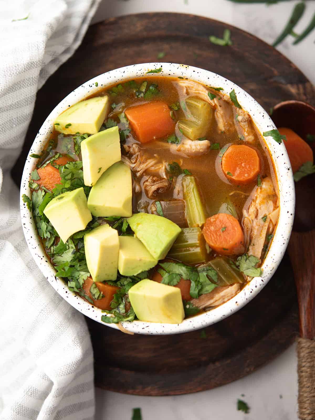 serving of cilantro chicken soup in bowl.
