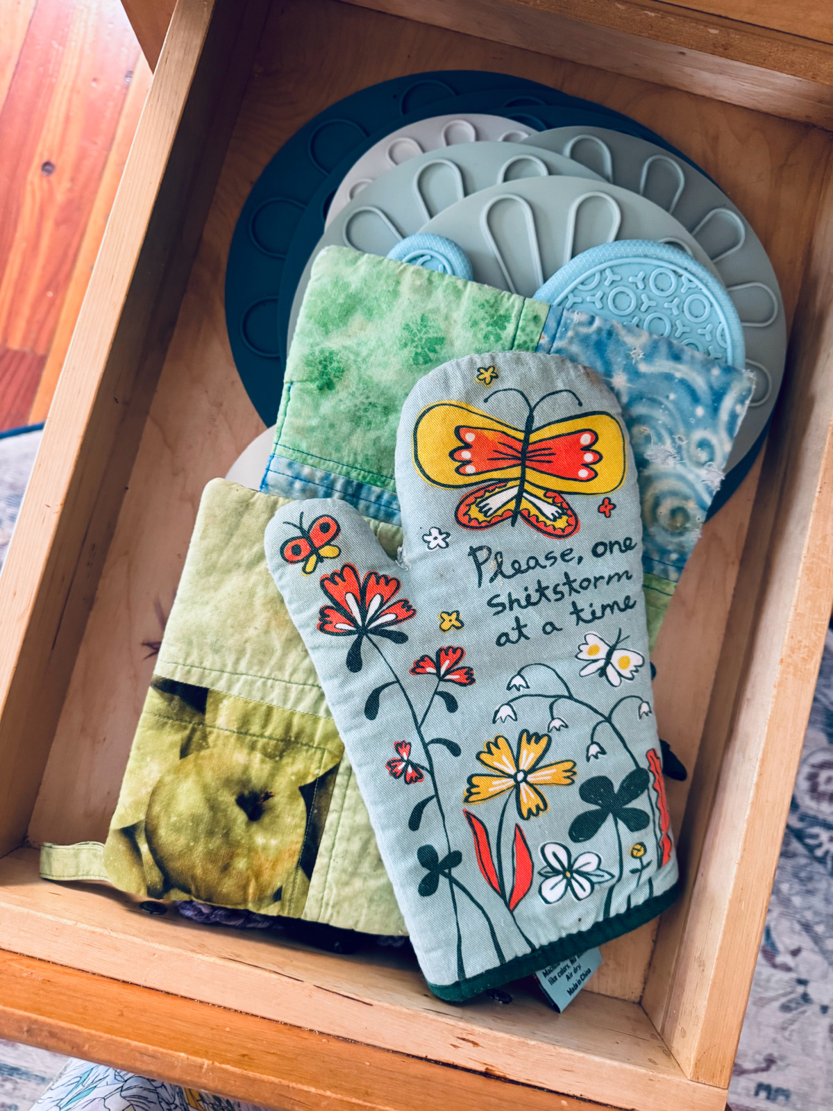 oven mitts and potholders in drawer.