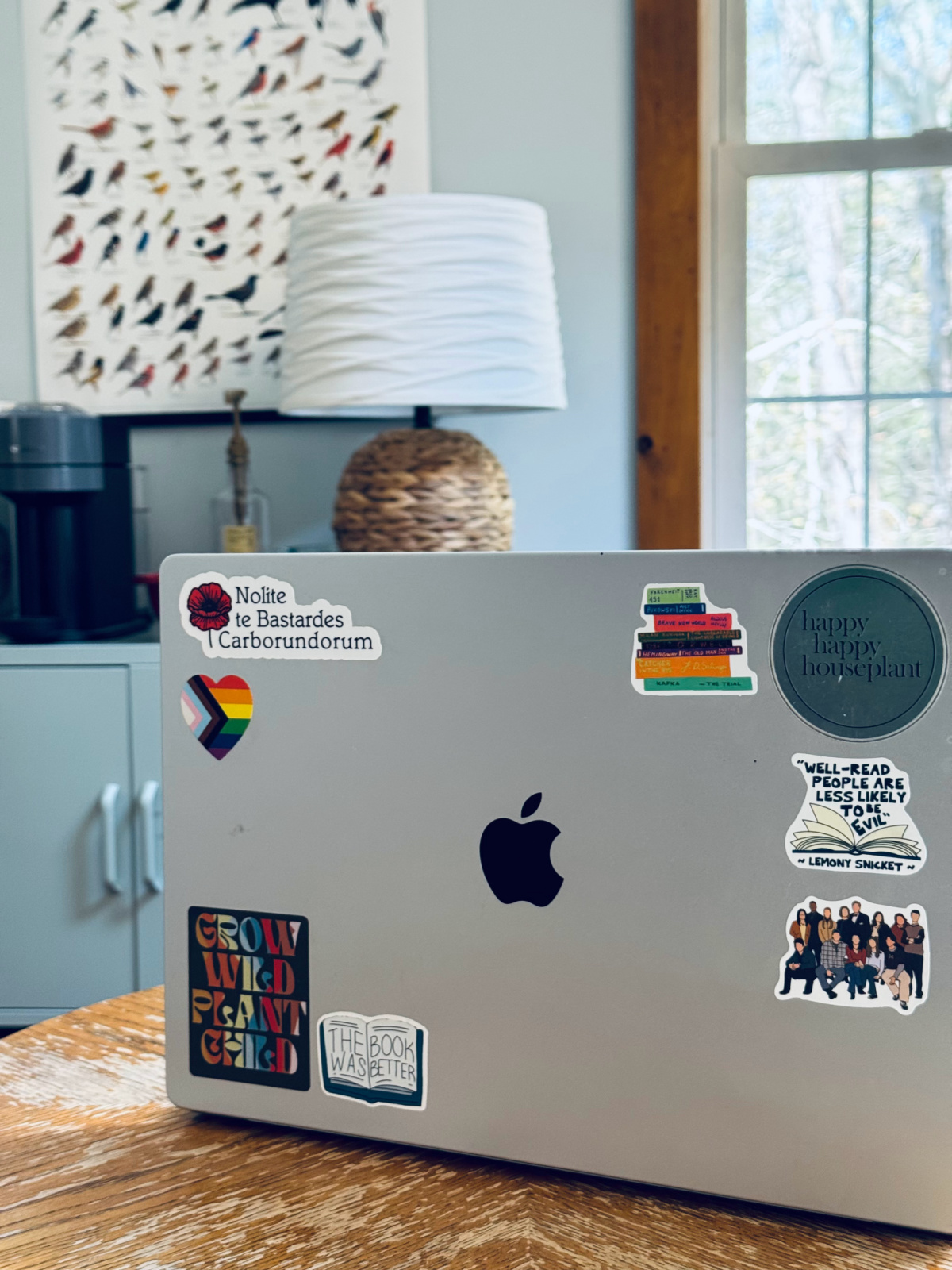 macbook computer with stickers like "the book was better".