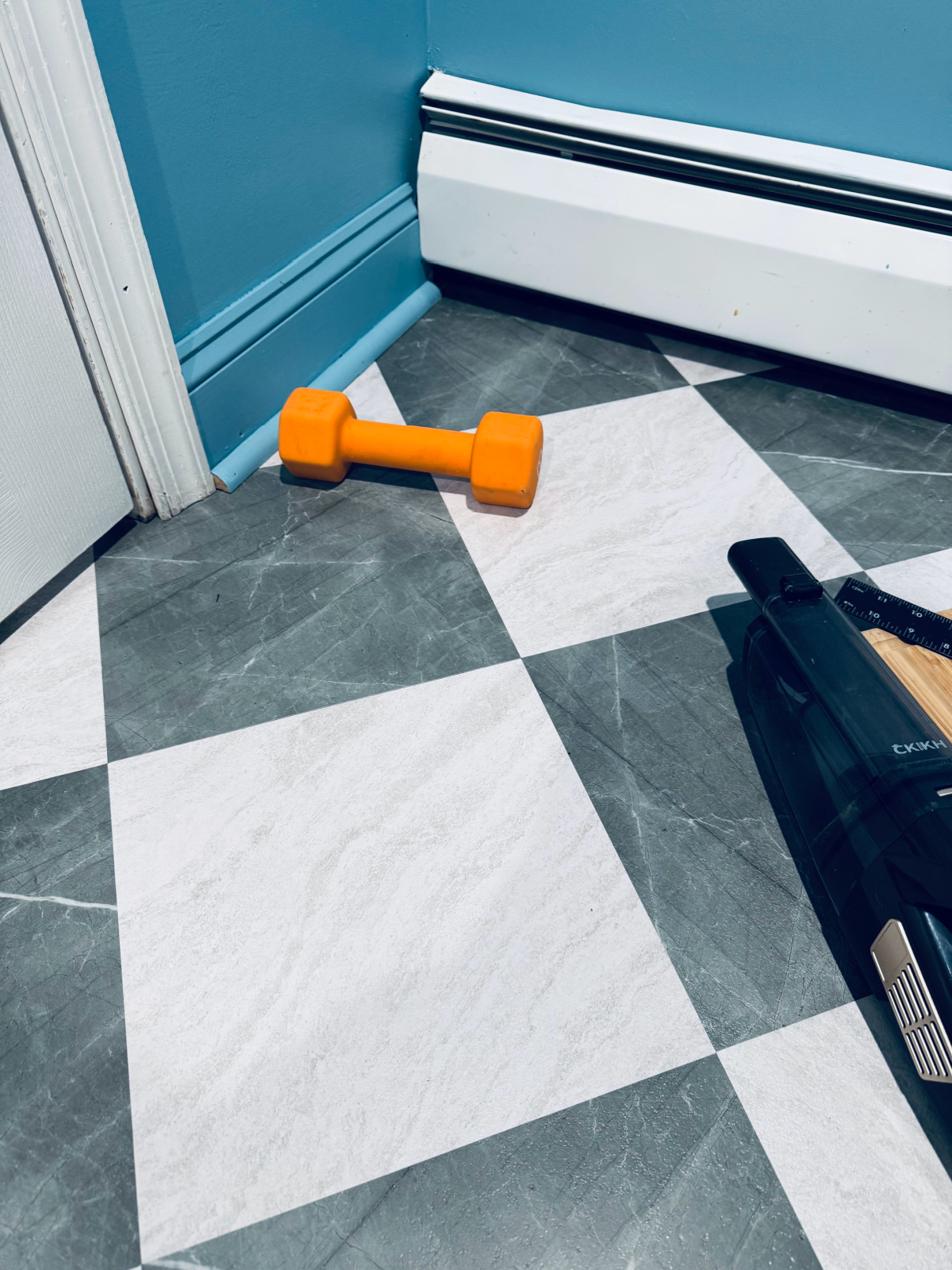 tiling in process, using weight to hold down tile.