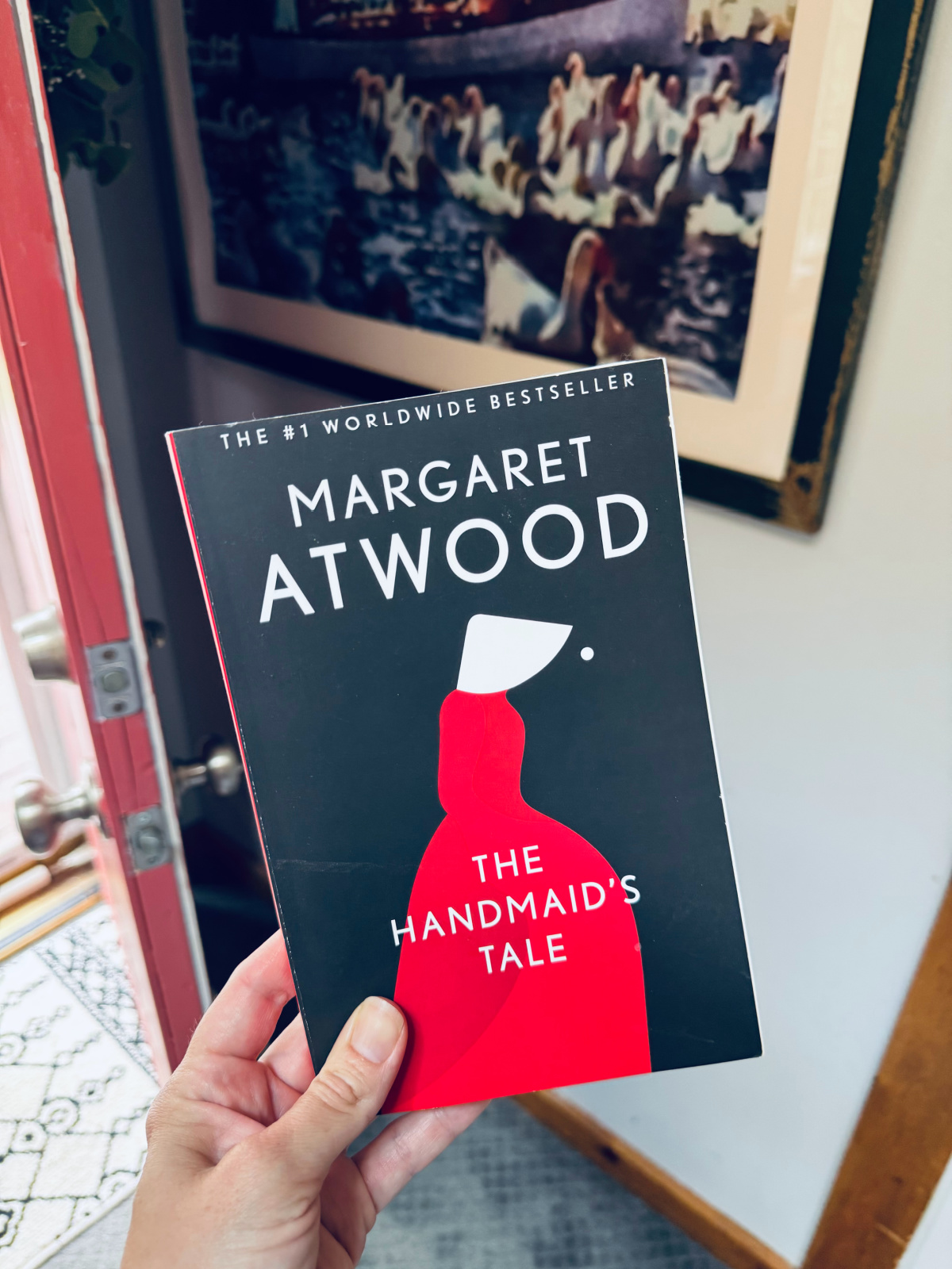 Margaret Atwood's The Handmaid's Tale book cover in focus.