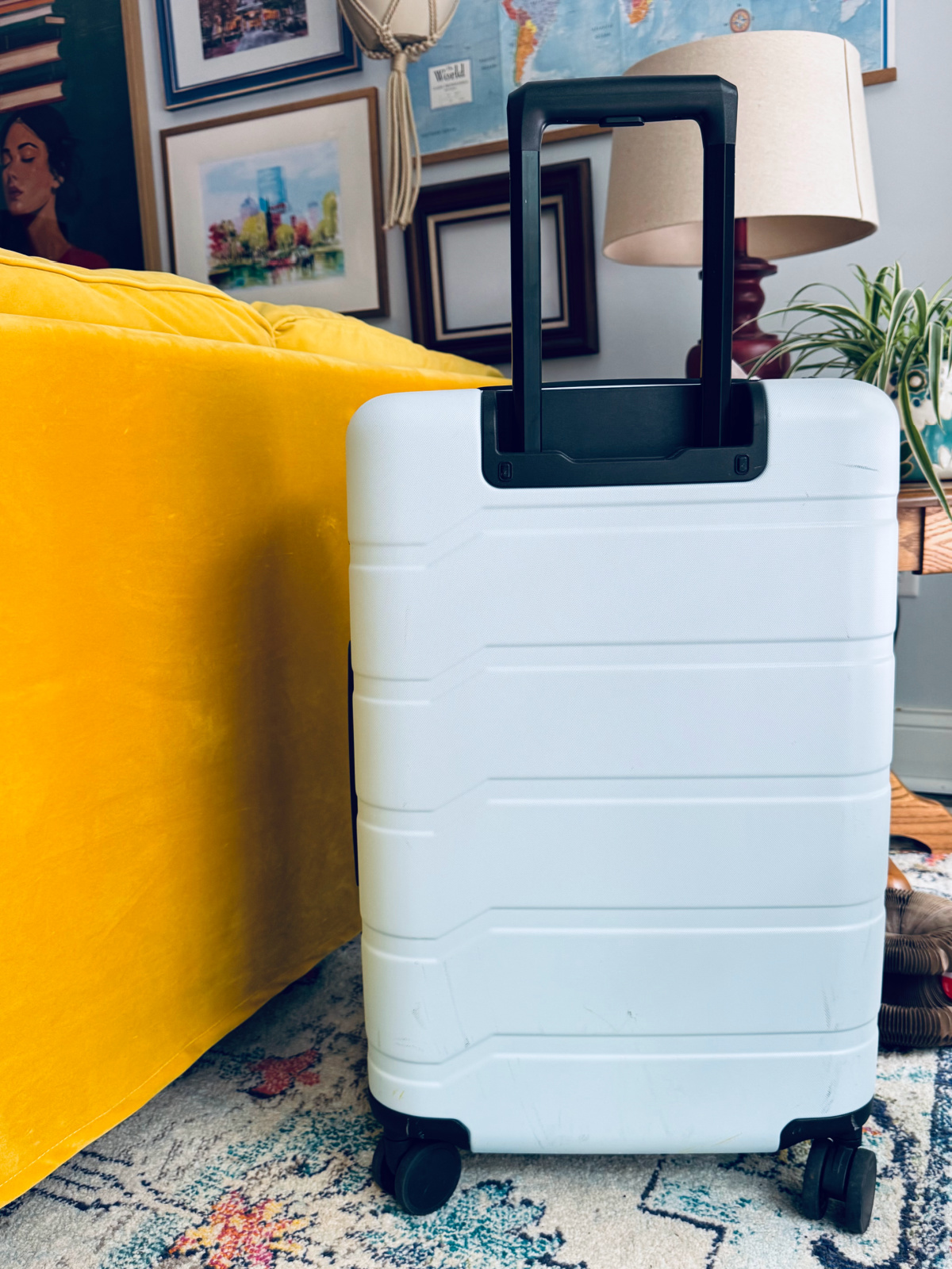 light blue suitcase in focus with declutter your bags theme. 