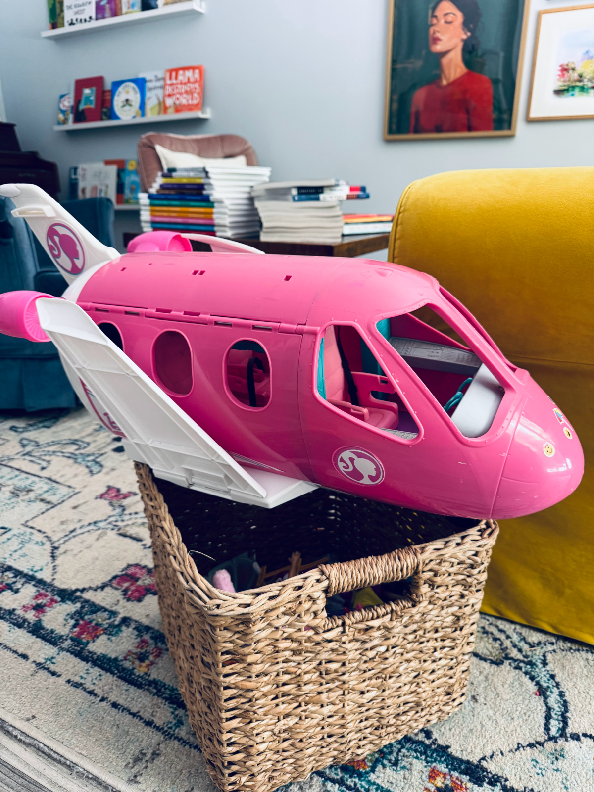 basket with decluttered Barbies and airplane to be given away.
