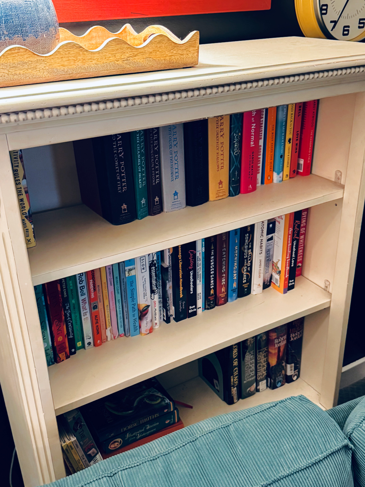 yellow bookshelf with books, showcasing the container concept for decluttering bookshelves.