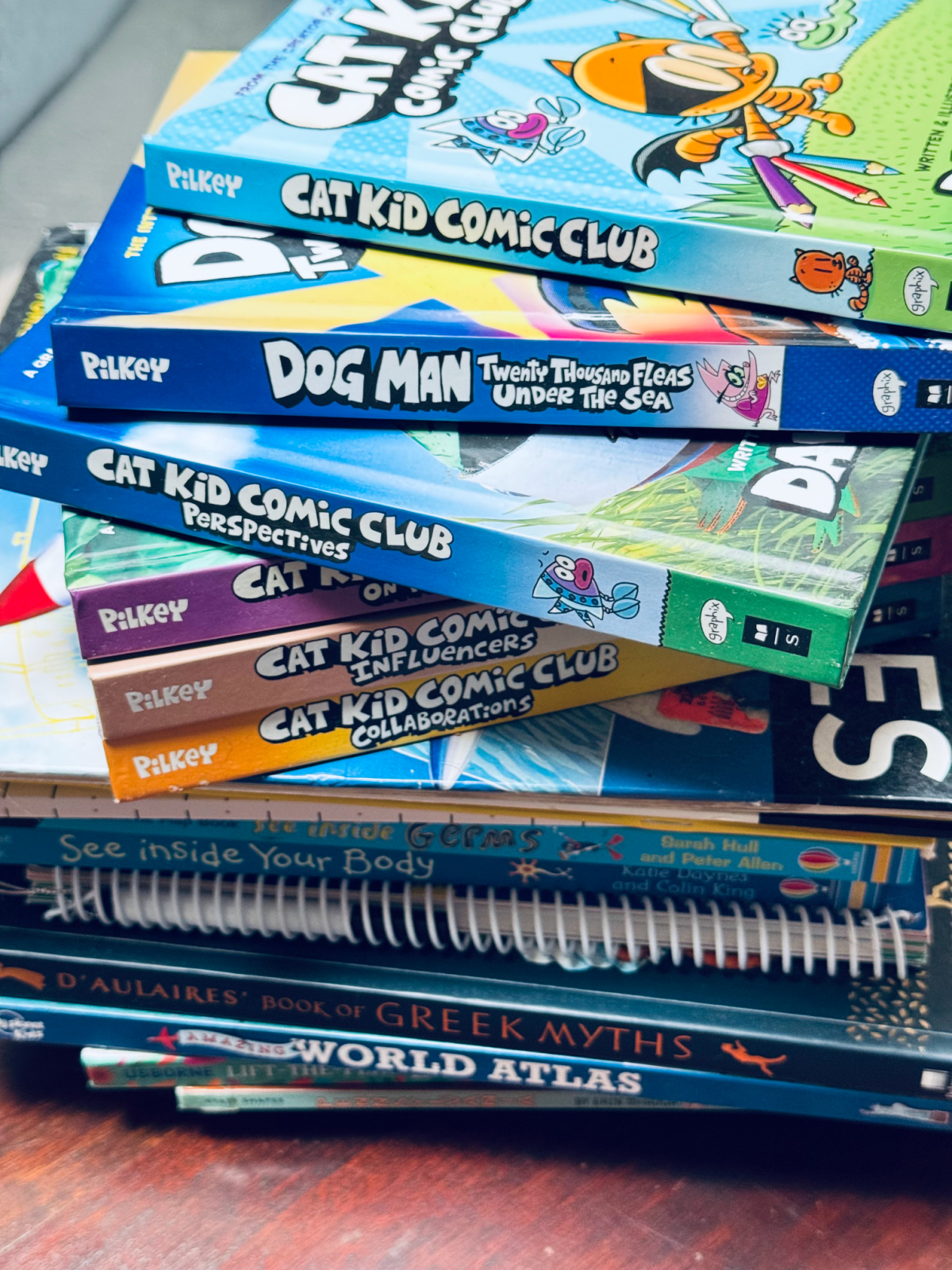 pile of decluttered books on counter, ready to be donated.