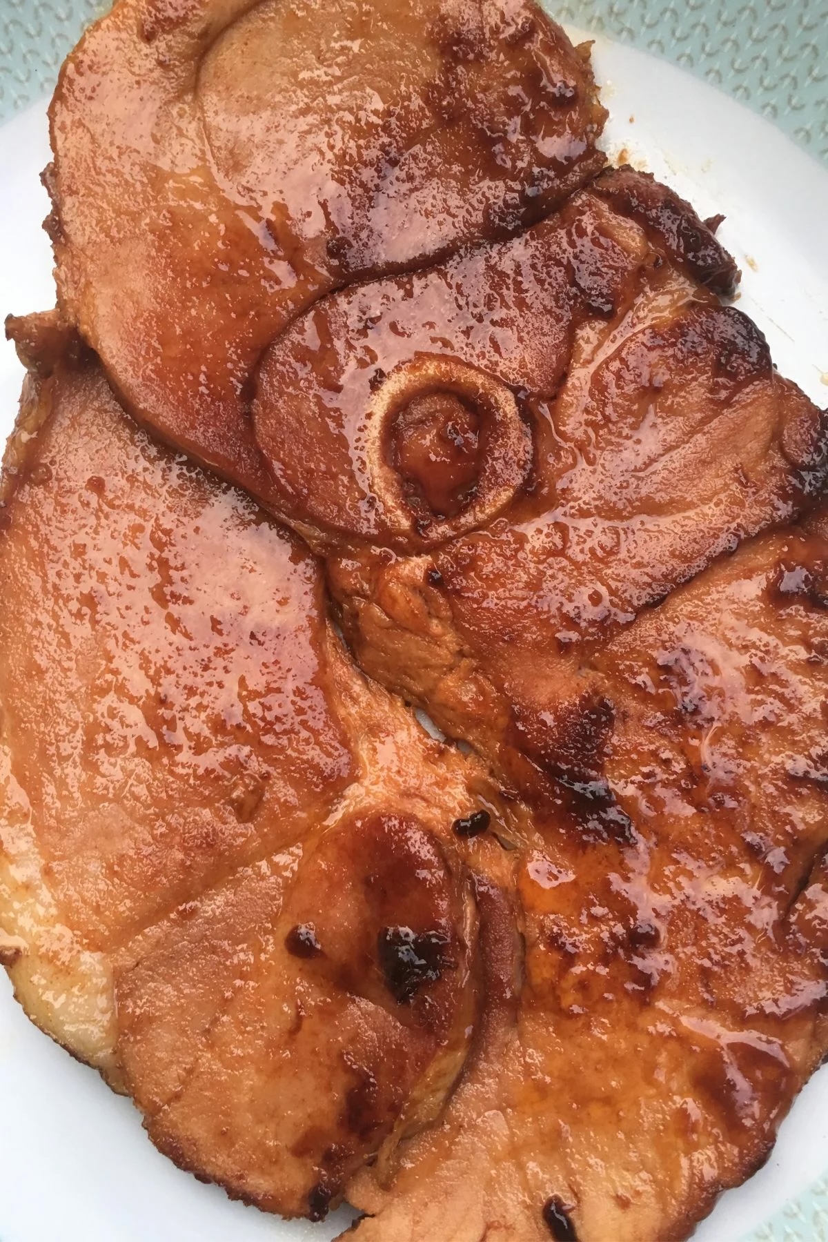 brown sugar glazed ham steak on plate.