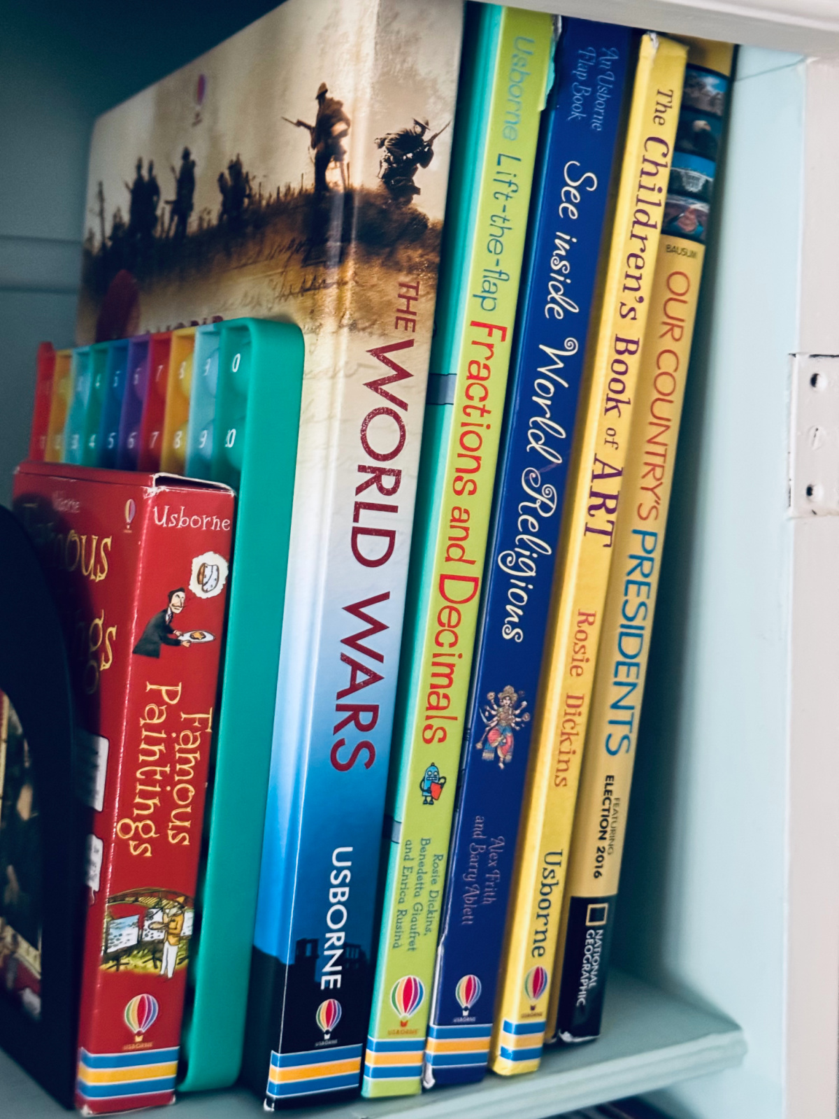 children's books on a bookshelf, needing to be decluttered.