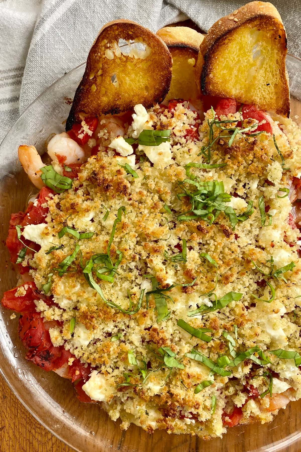 shrimp feta tomato bake with crostini.
